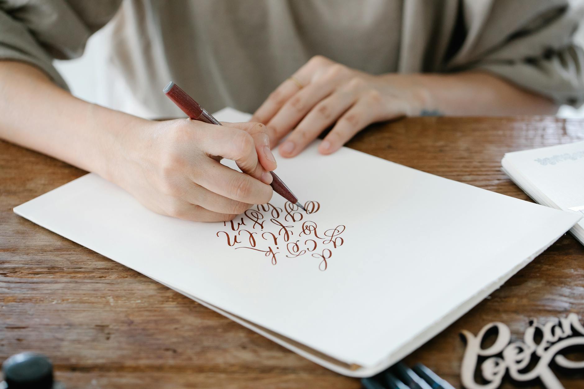 woman writing calligraphic letters
